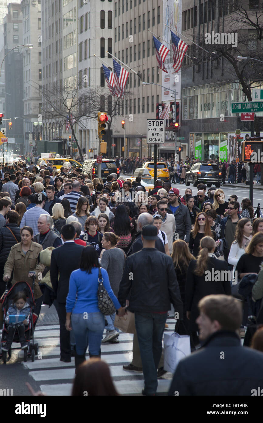 On Black Friday the busiest shopping day the street crowds are enormous on 5th Avenue near Rockefeller Center in NYC. Stock Photo
