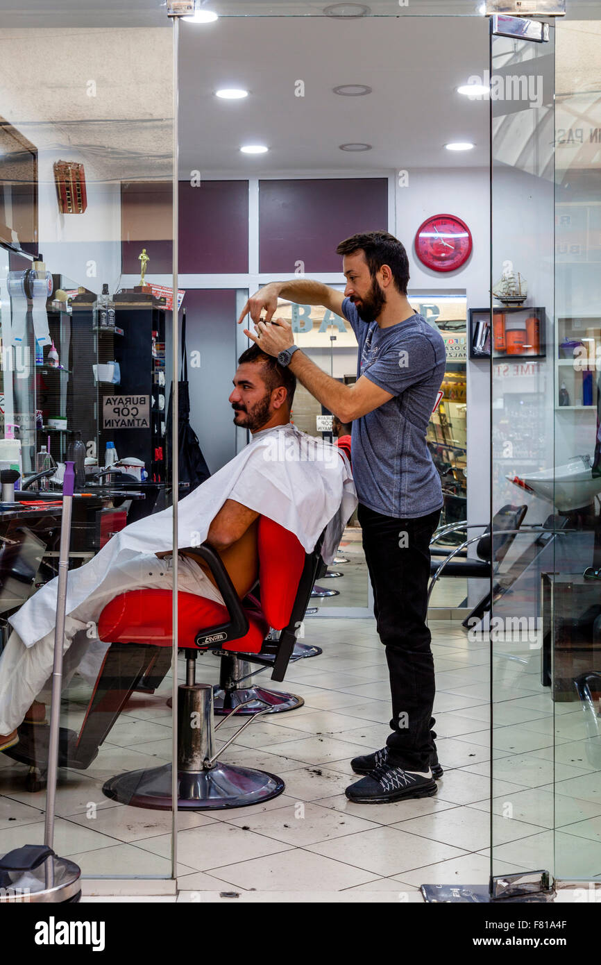 Turkish Hairdresser and Customer, The Grand Bazaar, Marmaris, Mugla Province, Turkey Stock Photo