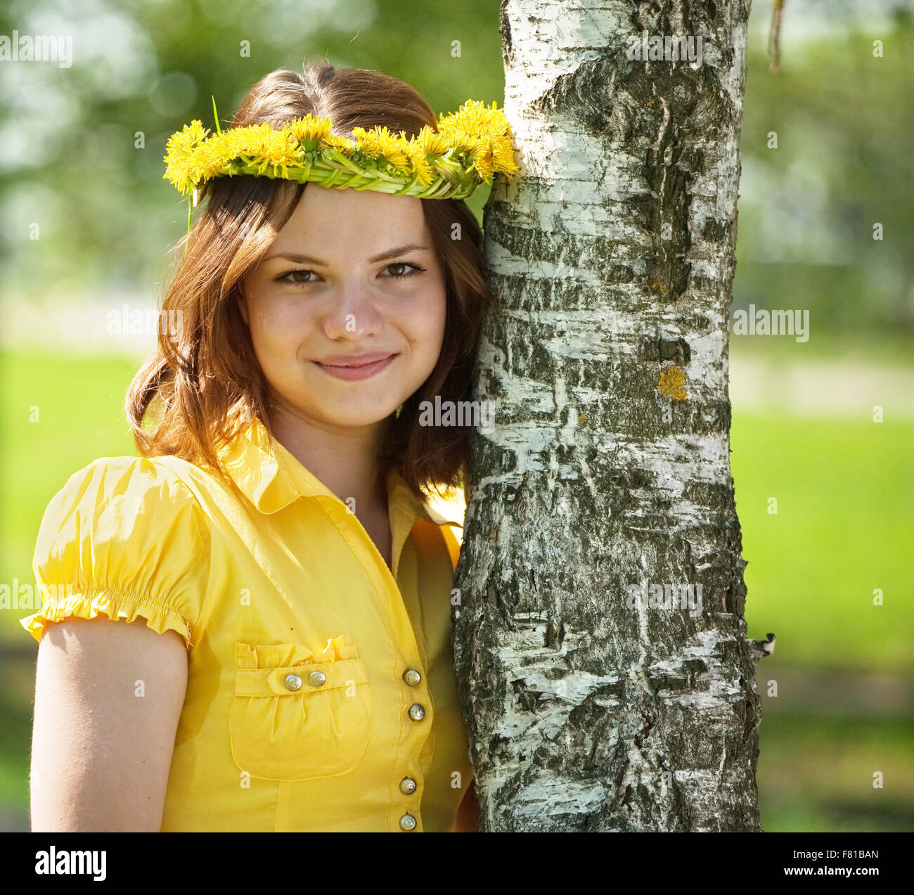 Brunette teen girl in flowers wreath near birch Stock Photo - Alamy