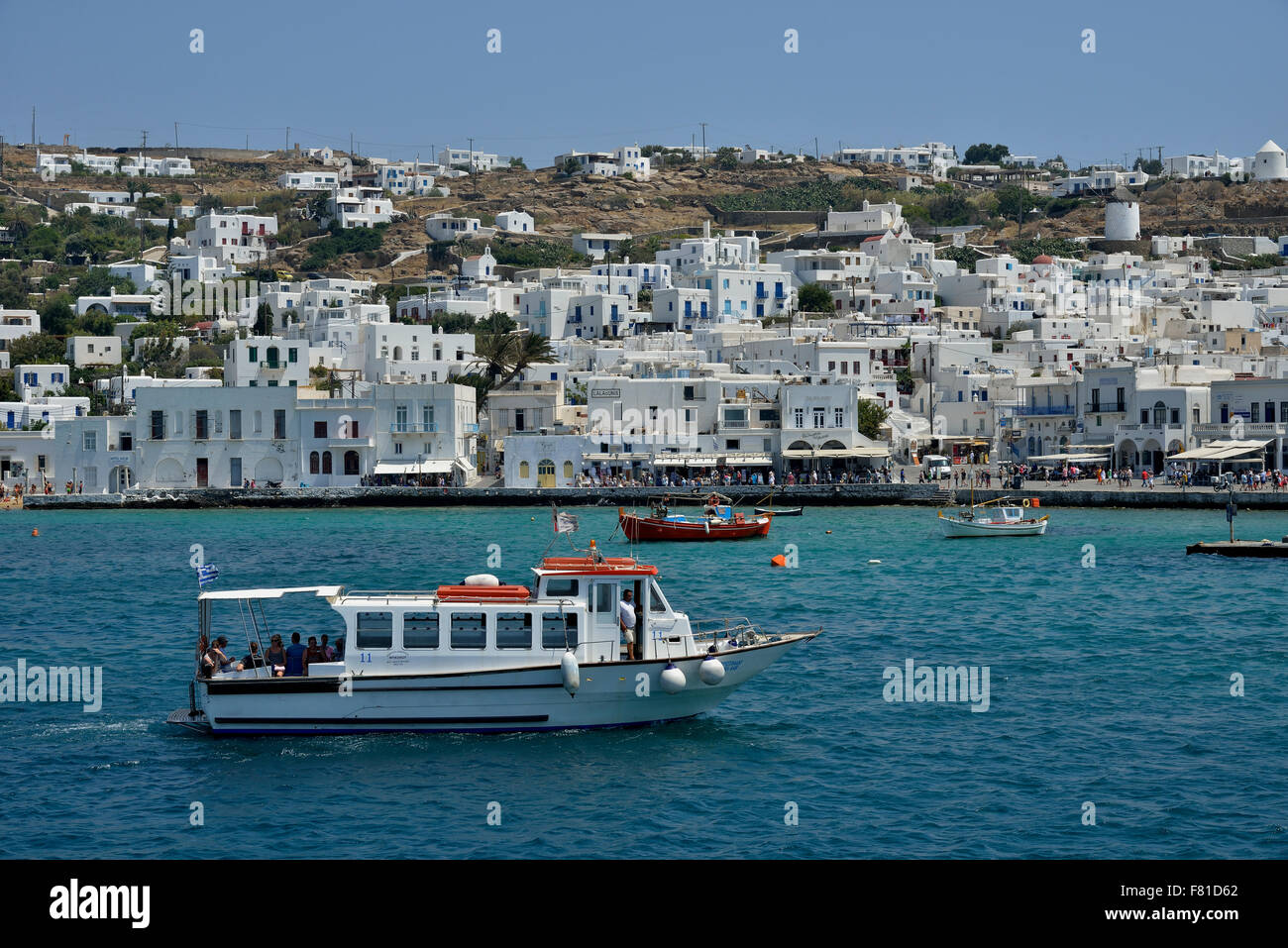 Excursion boat in the harbor of Mykonos Town or Chora, Mykonos, Cyclades, Greece Stock Photo