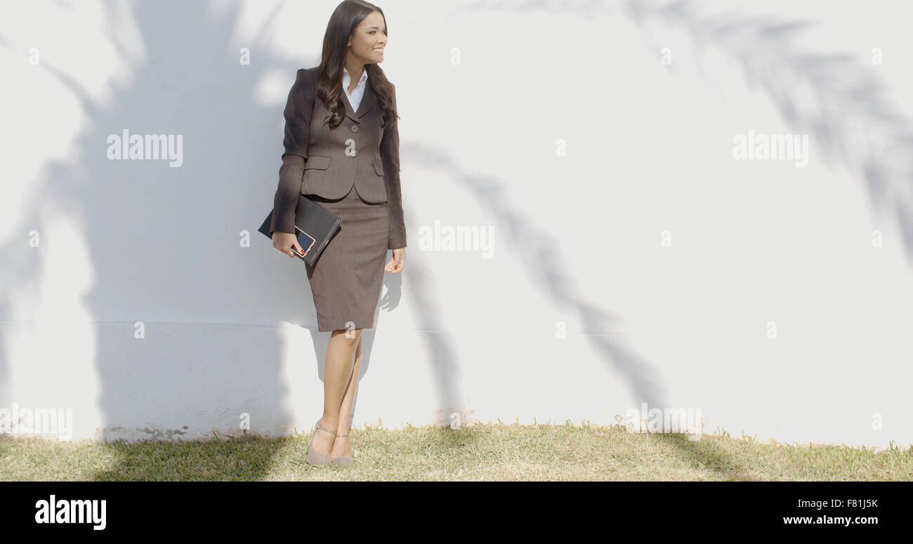 Business Woman Staying In Front Of A Wall Stock Photo