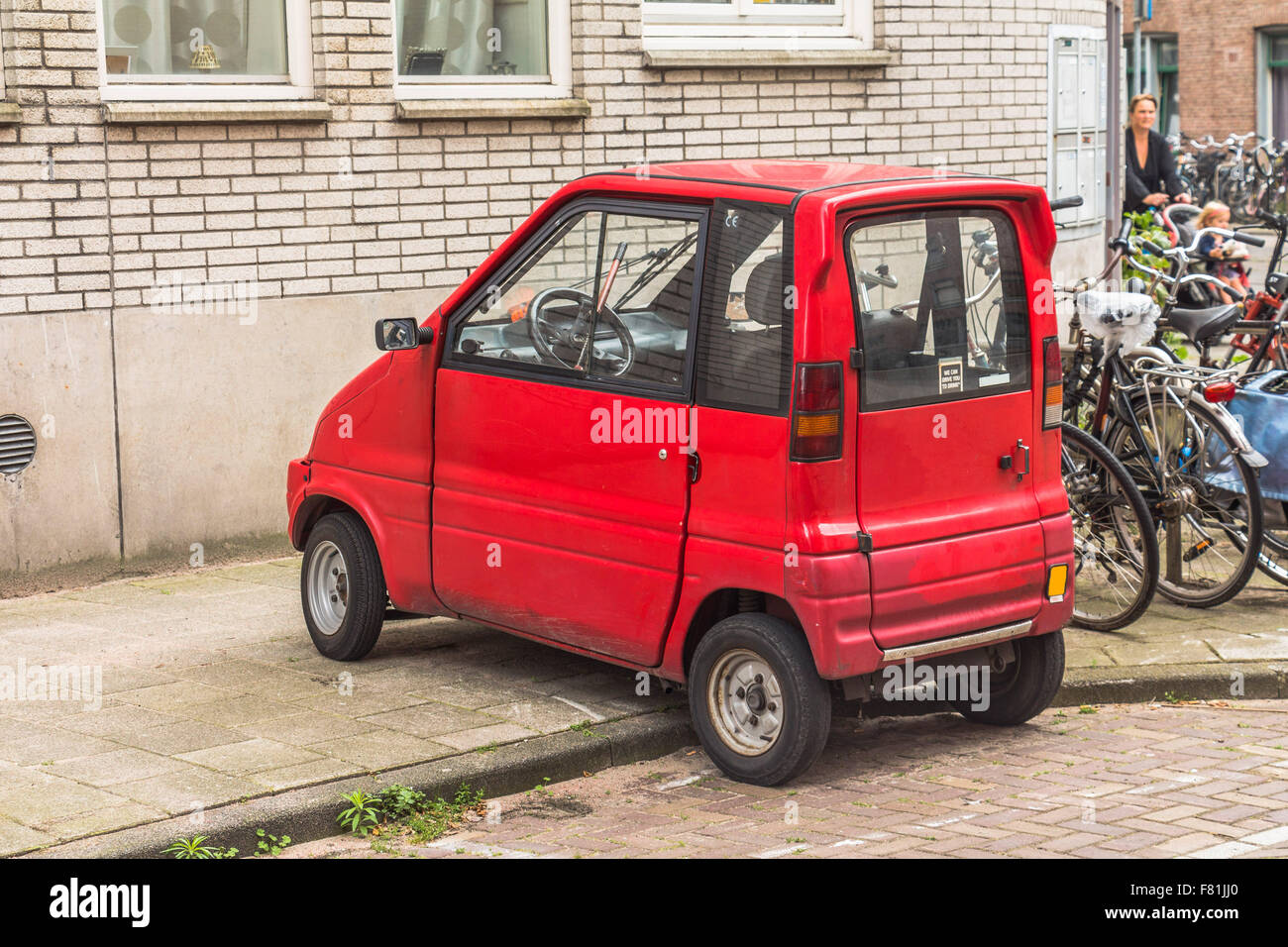Tiny city car in Amsterdam center Stock Photo Alamy