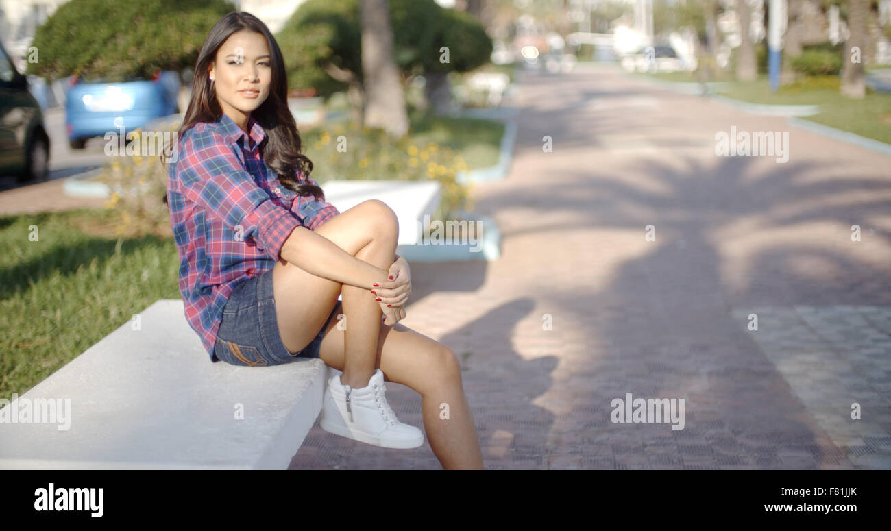 Young Woman Sitting In A Summer Park Stock Photo - Alamy