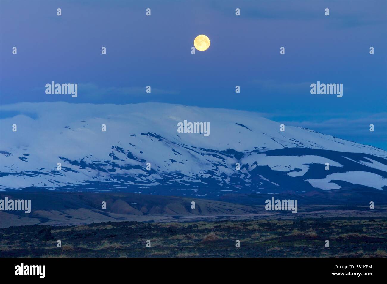 Full moon over Mount Hekla, an active volcano in Iceland. Stock Photo