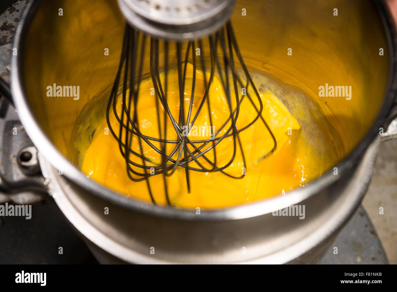 Whipping eggs with a metal whisk in a pastry Stock Photo Alamy