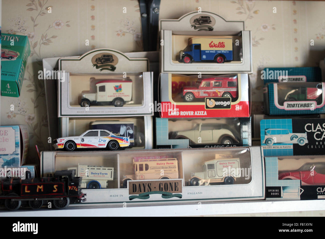 Model toy cars and vans in box and a small train Stock Photo - Alamy