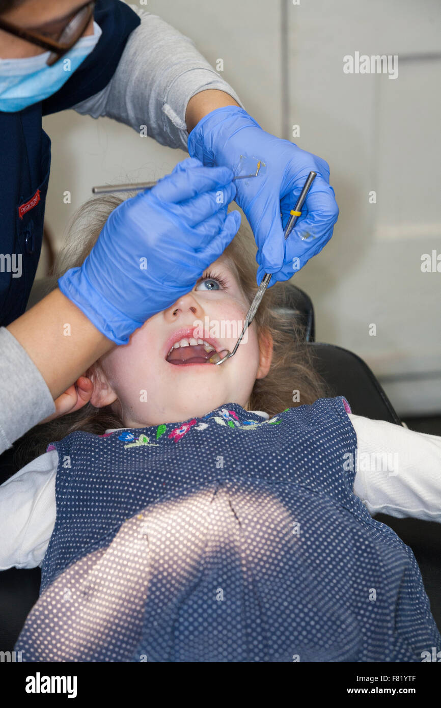 Fluoride varnishing varnish on 3 yr three year old child girl during
