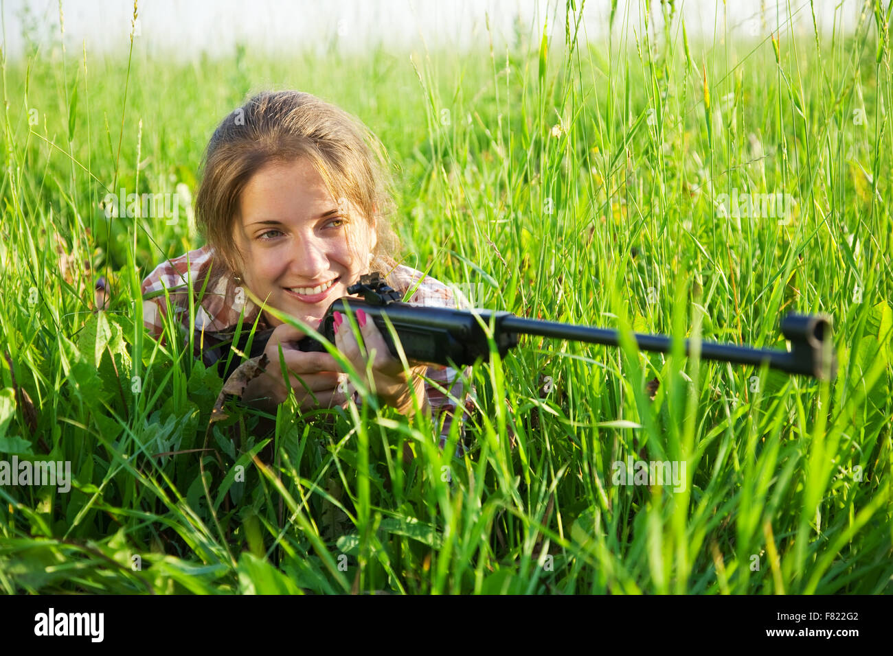 Young woman aiming with hunting rifle hi-res stock photography and ...