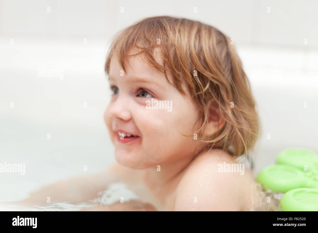 Happy twoyear baby girl bathes in bathtub Stock Photo Alamy