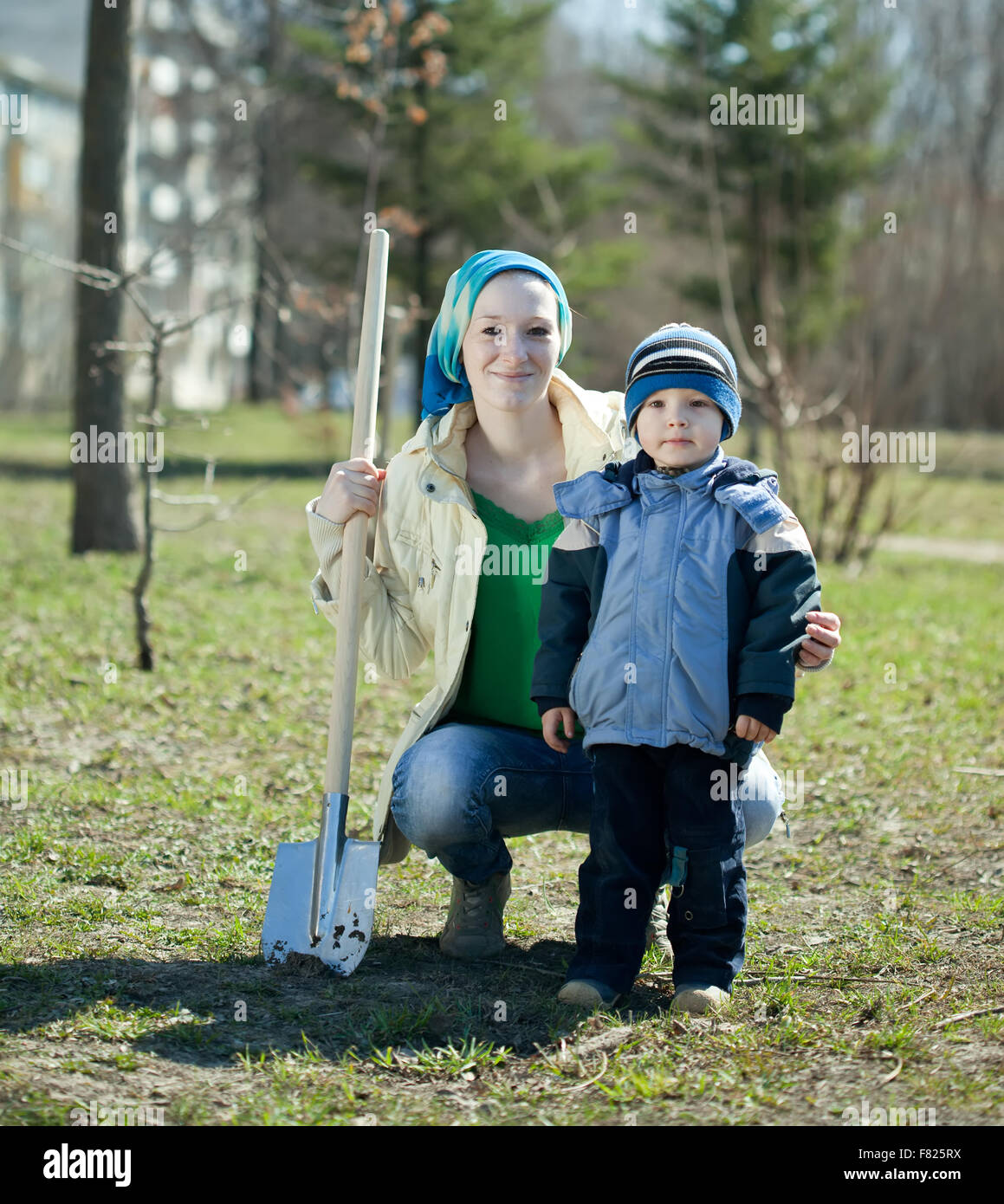young woman and boy with spade in park Stock Photo - Alamy