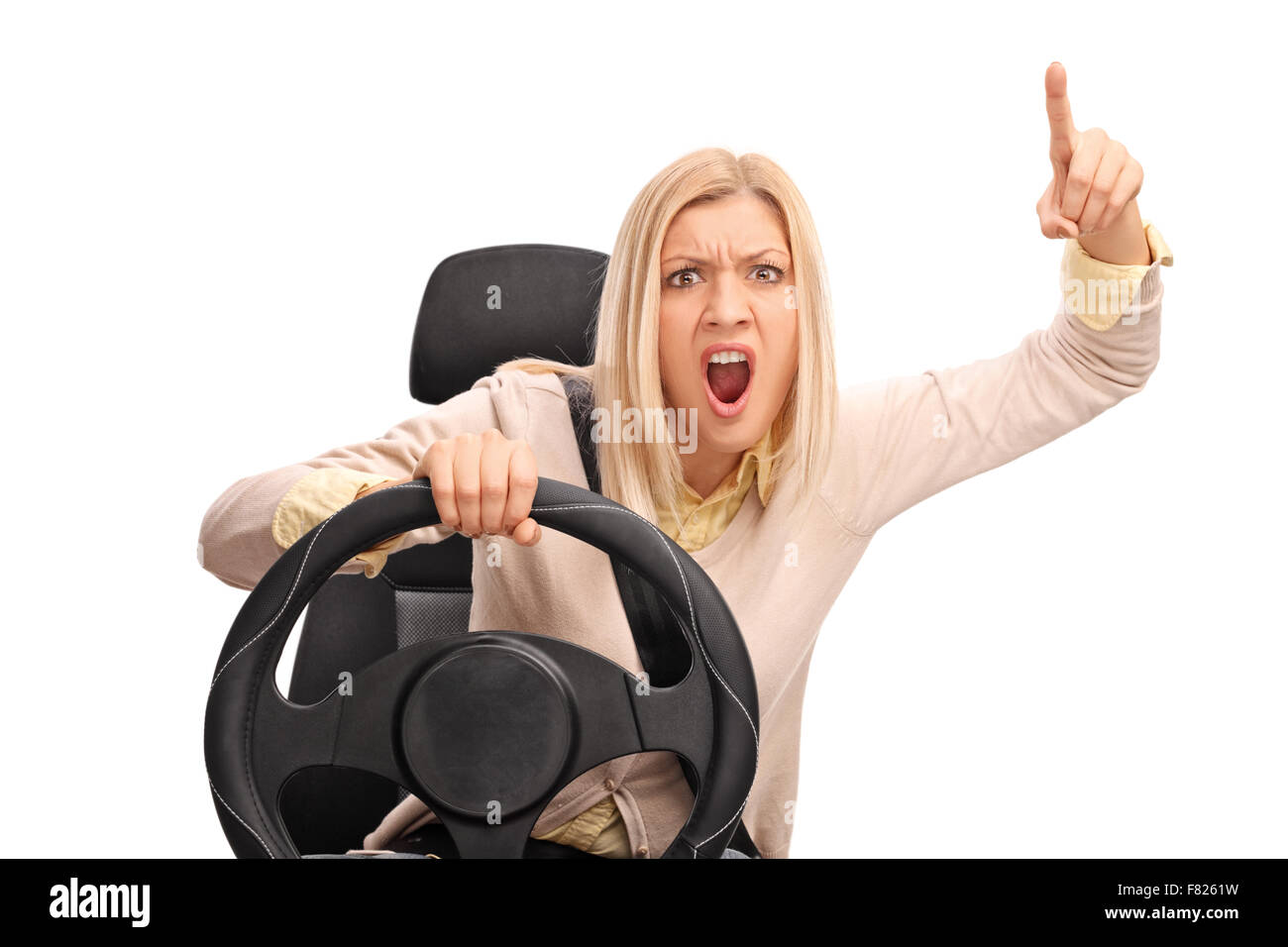 Angry woman pretending to drive and shouting towards the camera isolated on white background Stock Photo