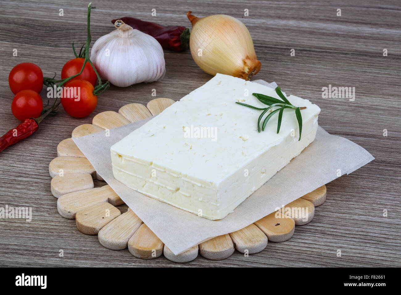 Traditional Caucasian homemade Cheese Brinza with rosemary on wood background Stock Photo