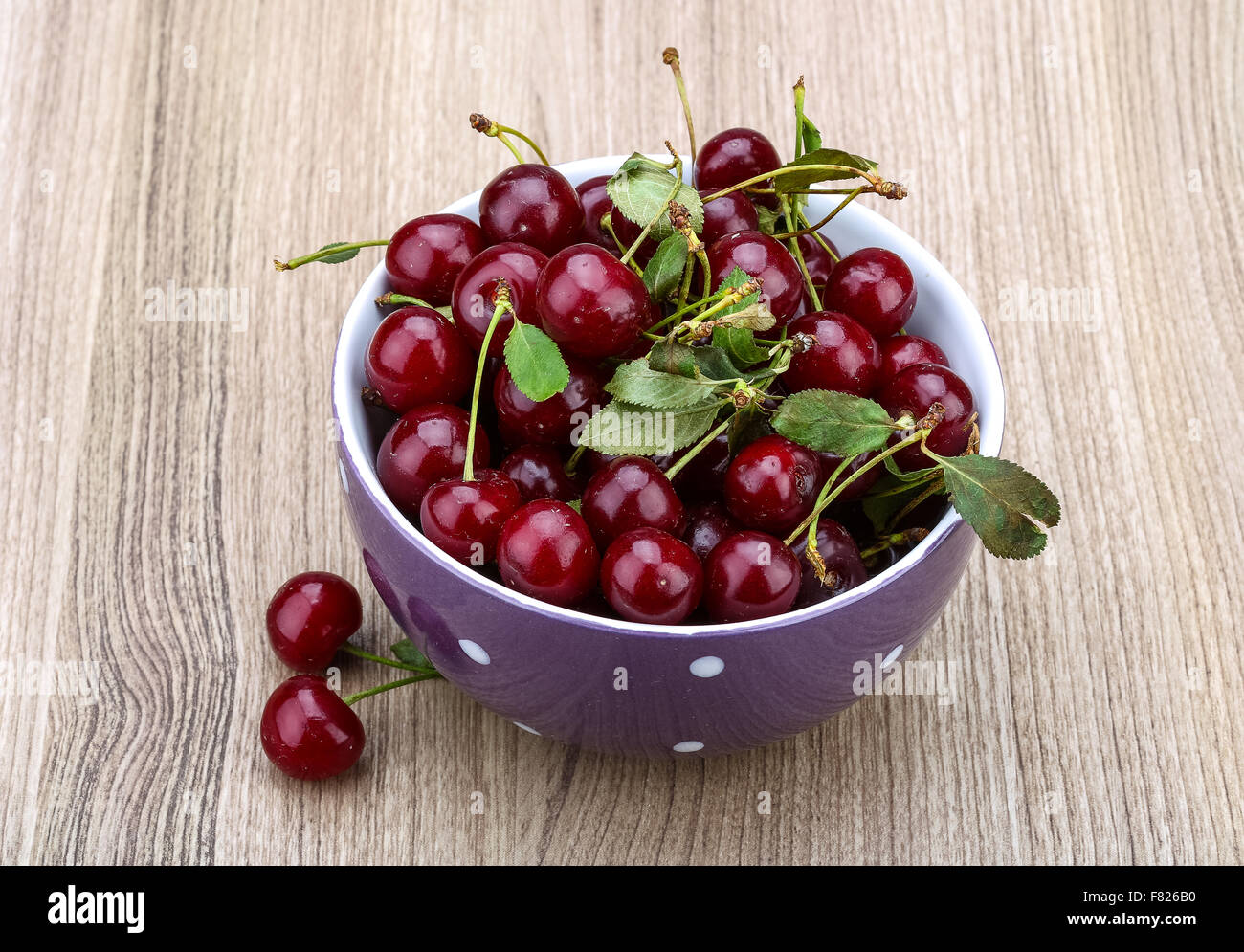 Fresh ripe Cherry in the bowl on wood background Stock Photo - Alamy