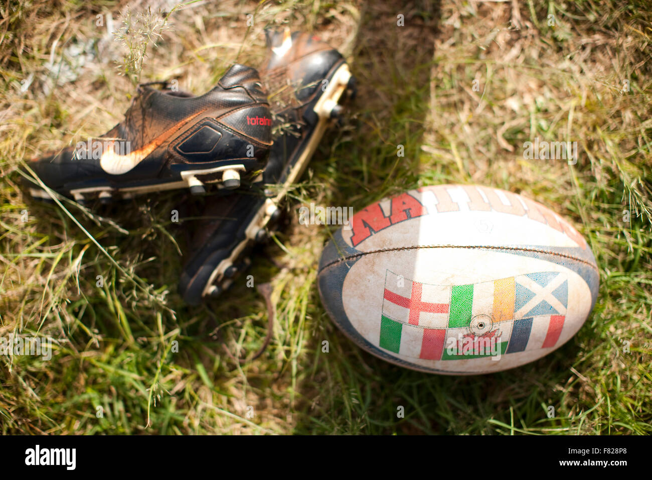 Rugby ball and cleats Stock Photo