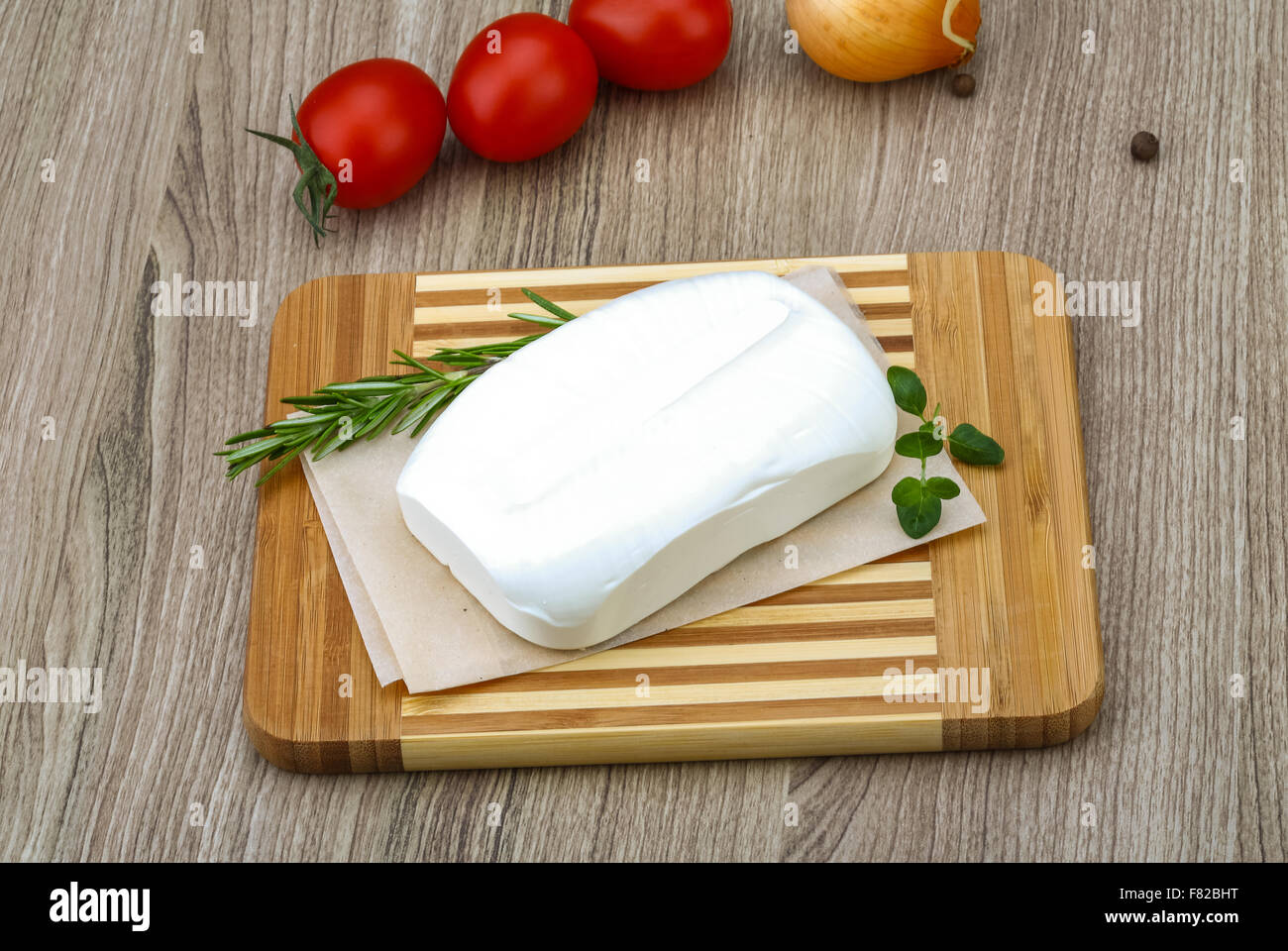 Traditional Greek cheese - Feta with herbs on the wood background Stock ...