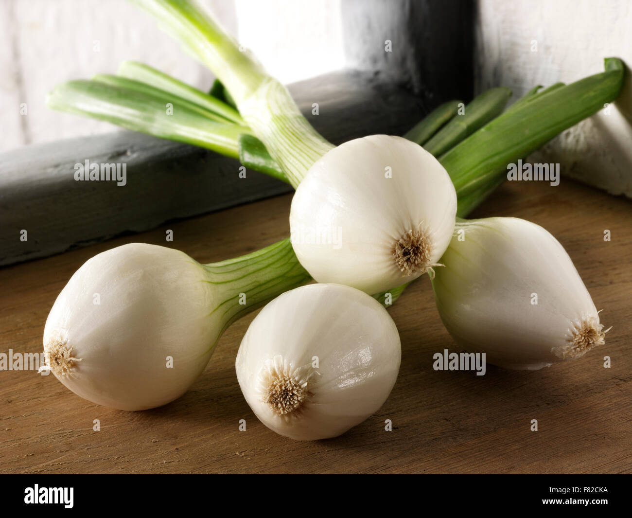 still life of a bunch of fresh spring onions, salad onions, in a kitchen setting Stock Photo Alamy