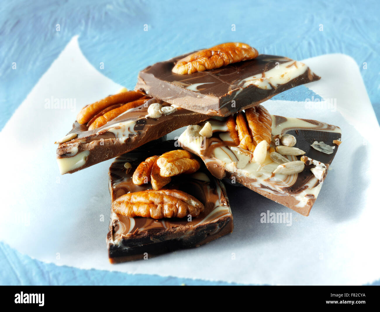 milk and white chocolate slabs pieces with pecan nuts Stock Photo