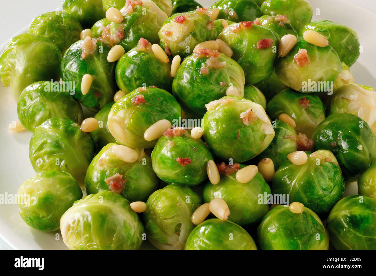 Cooked brussel sprouts with pine nuts Stock Photo