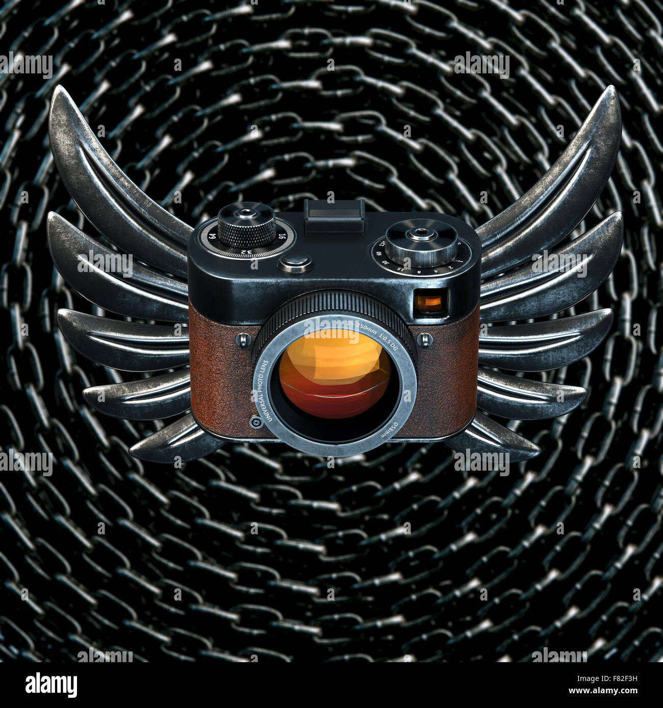 Vintage film photo camera with metal Wings on metal chain background ...