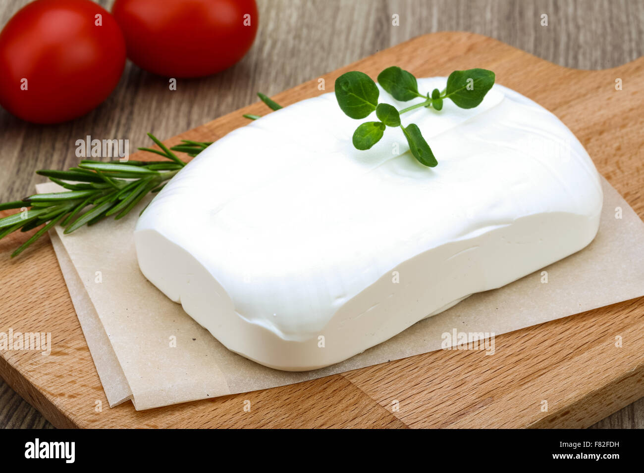 Traditional Greek cheese - Feta with herbs on the wood background Stock ...
