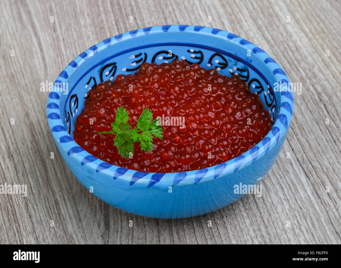 Red caviar in the bowl with green parsley leaf Stock Photo Alamy