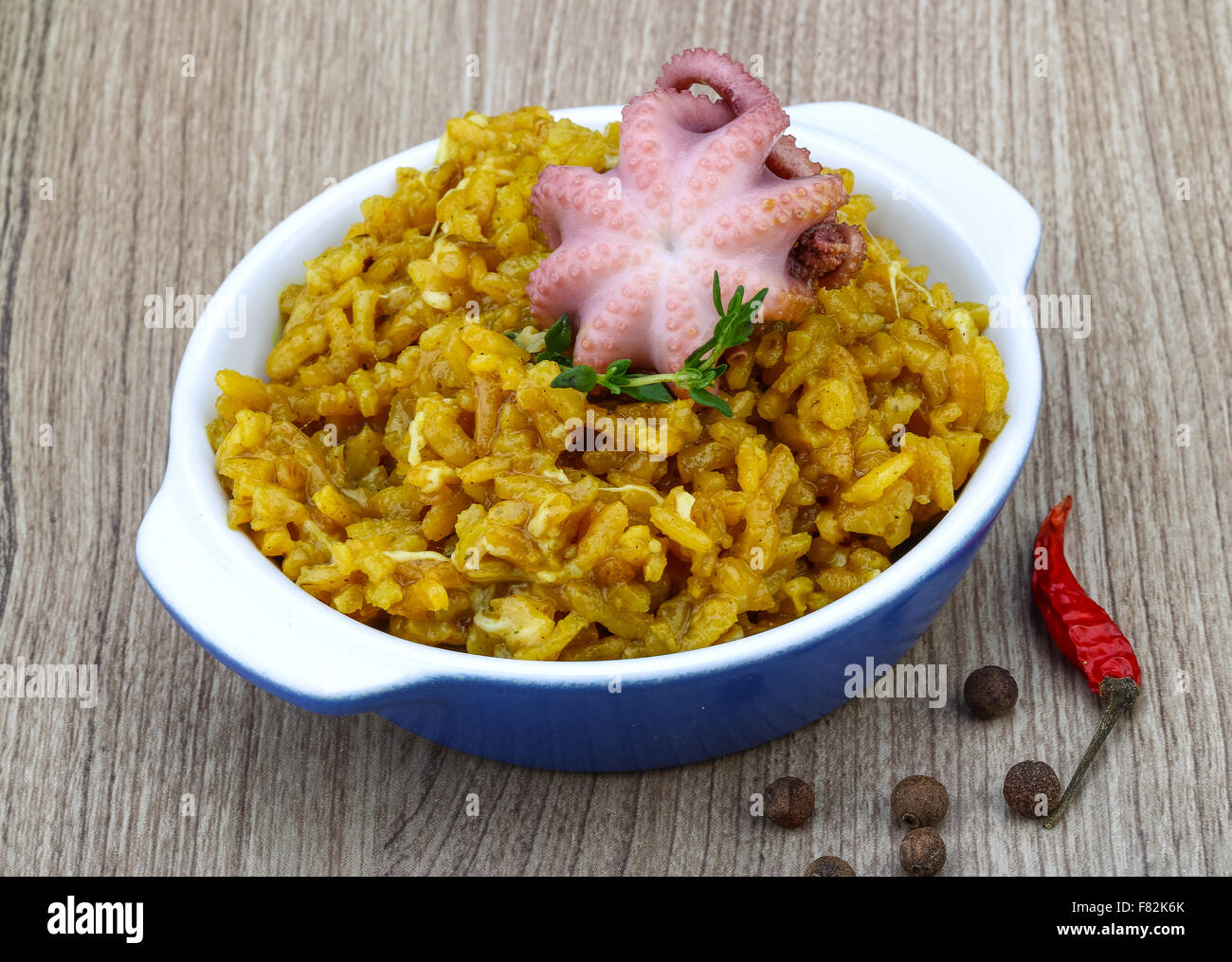 Seafood risotto with octopus, cheese and thyme leaf Stock Photo - Alamy
