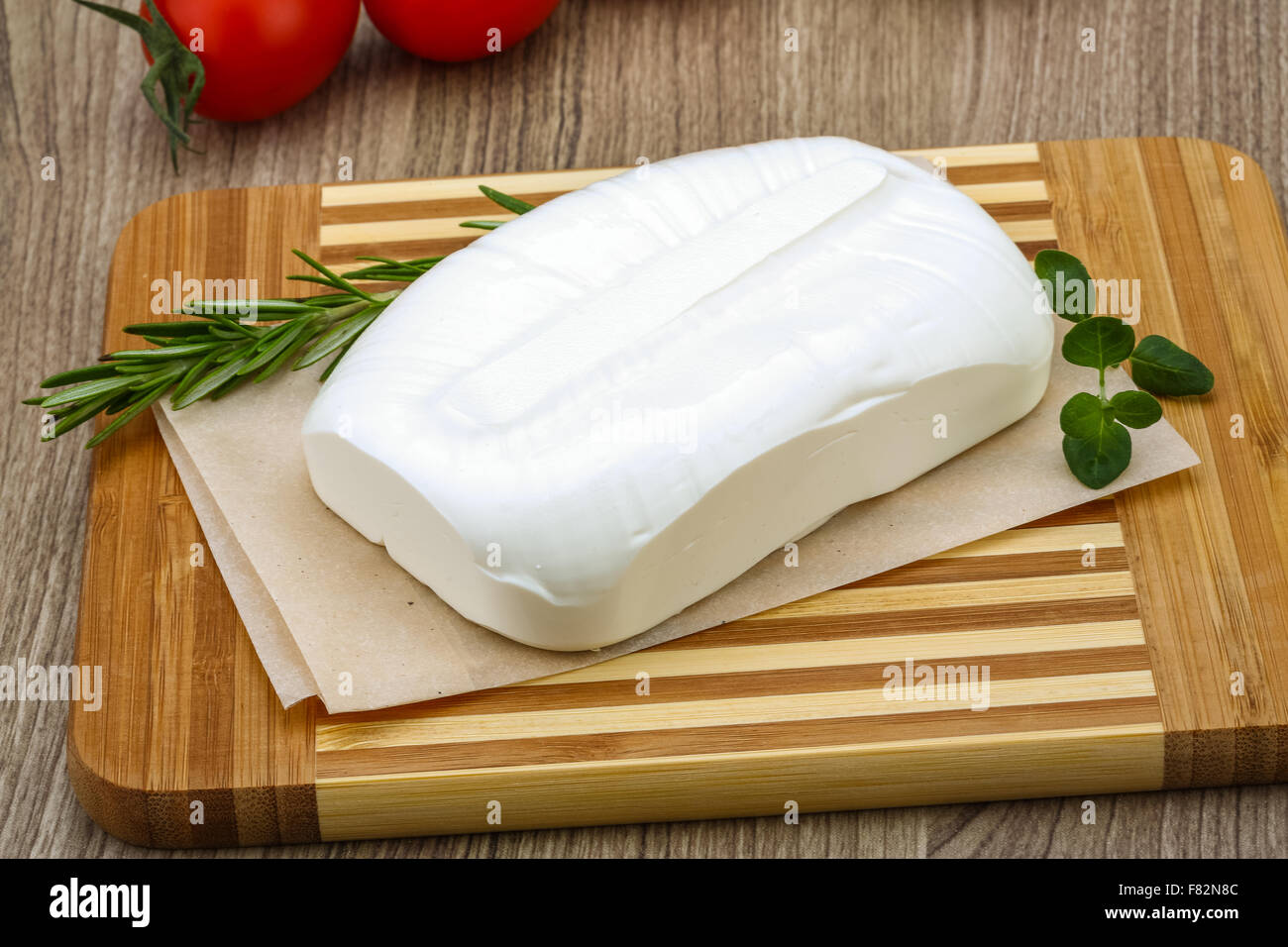 Traditional Greek cheese - Feta with herbs on the wood background Stock ...