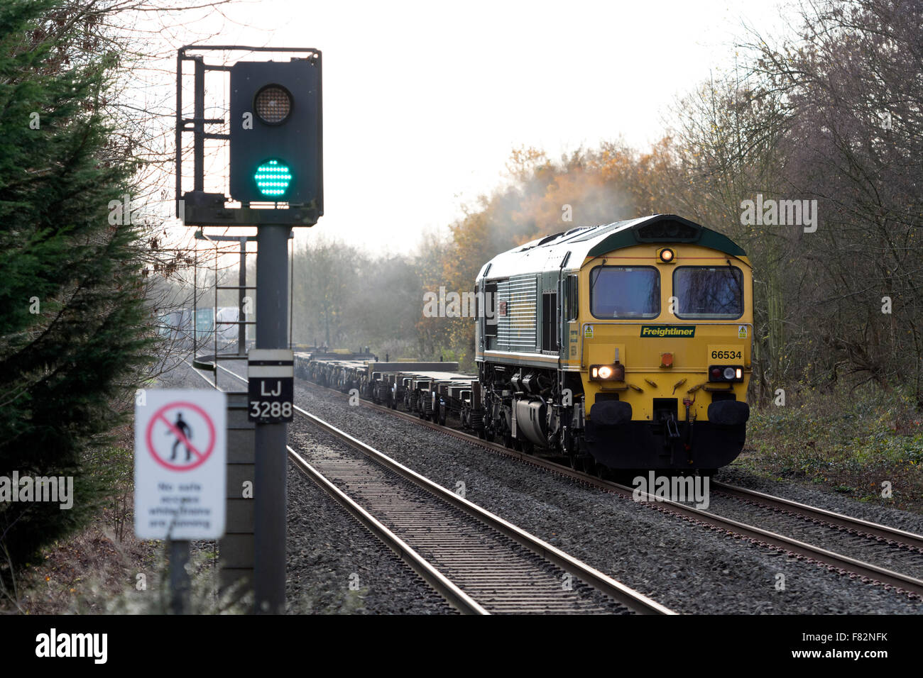 A Class 66 diesel locomotive pulling a freight train at Lapworth, Warwickshire, England, UK Stock Photo