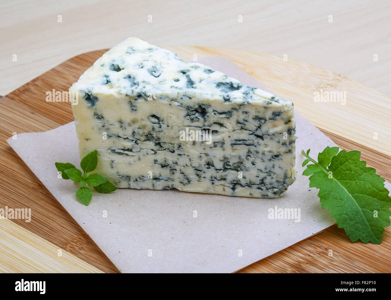 Dor Blue cheese with basil on the wood background Stock Photo - Alamy