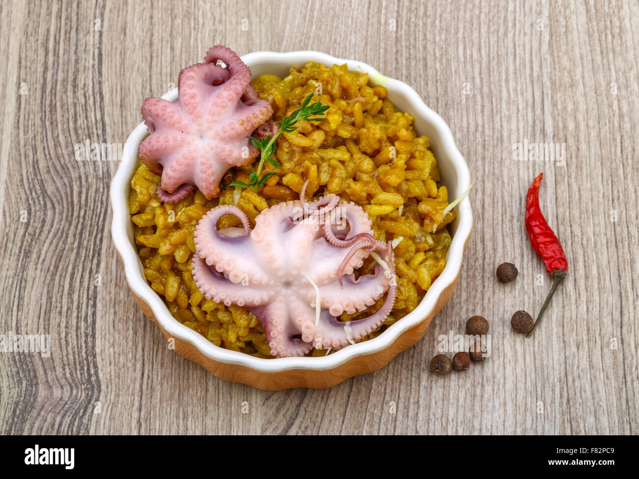 Seafood risotto with octopus, cheese and thyme leaf Stock Photo - Alamy