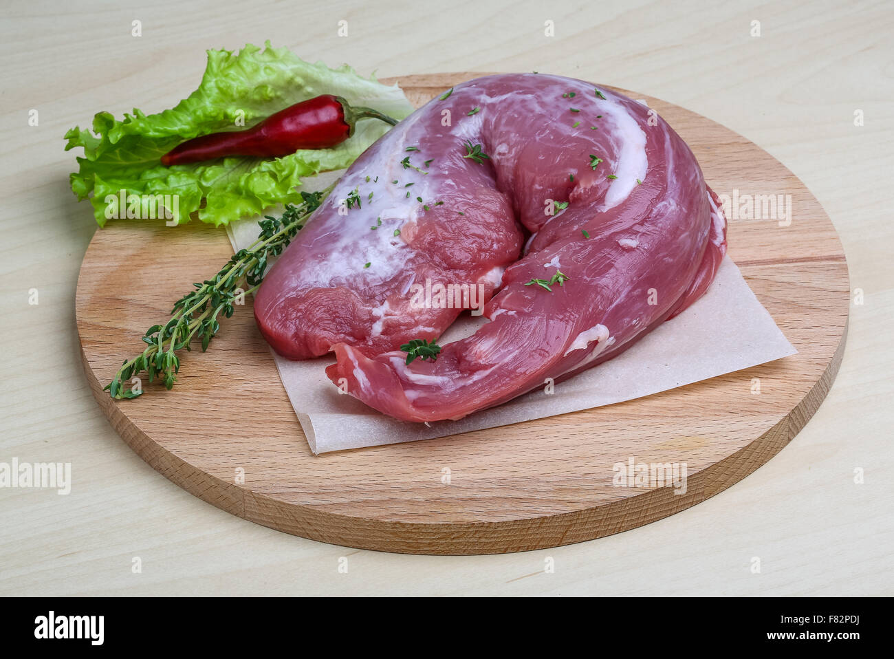 Raw pork tenderloin with thyme and pepper ready for cooking Stock