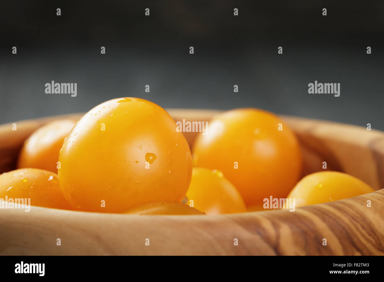 yellow cherry tomatoes in wood bowl Stock Photo - Alamy