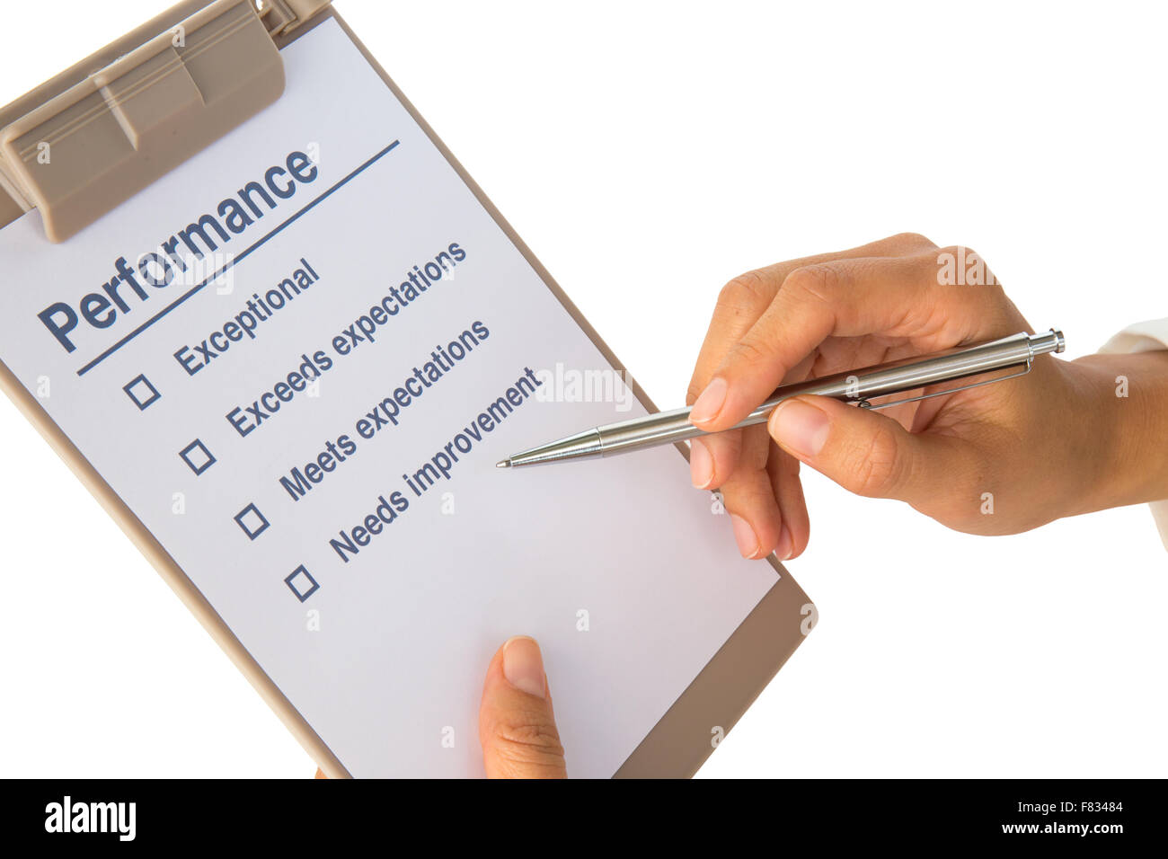 Woman's hand fills out performance checklist on white Stock Photo