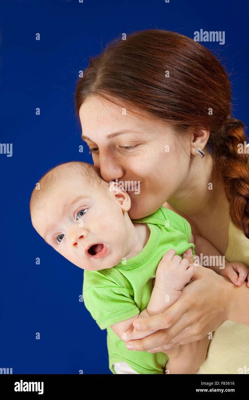 mother with her baby over blue background Stock Photo - Alamy