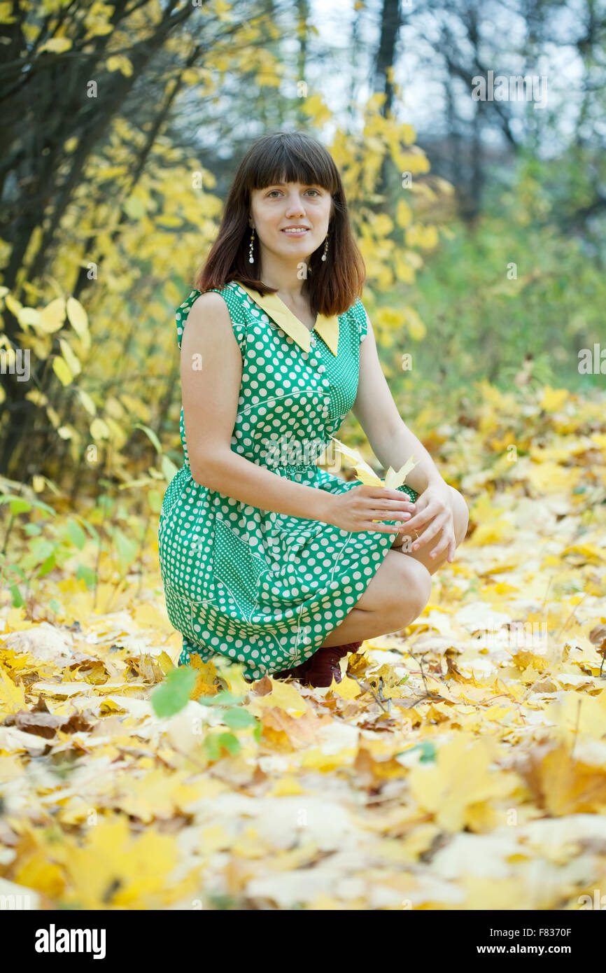 Girl in green dress at autumn park Stock Photo - Alamy
