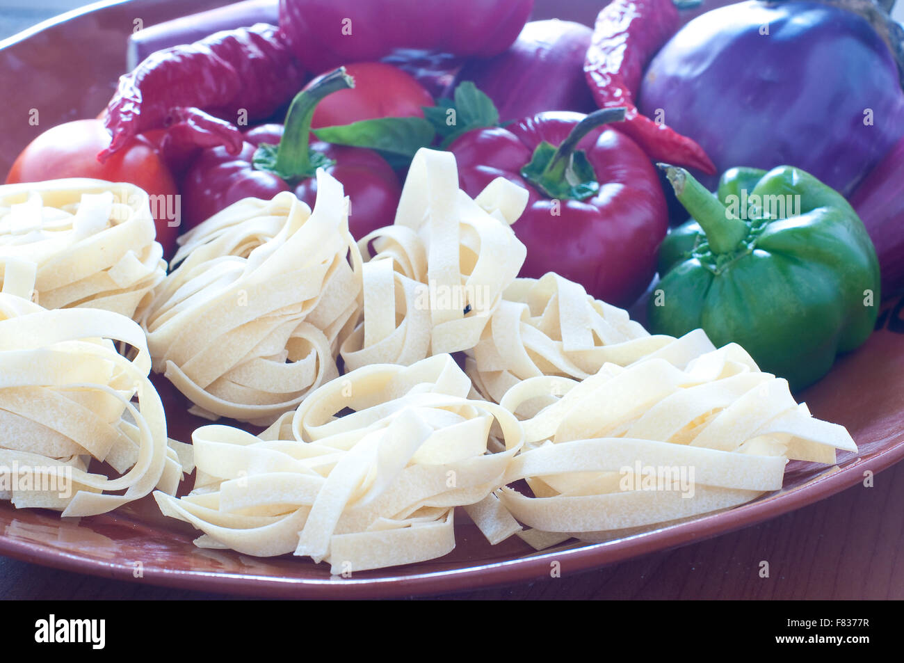 Typical Italian pasta called ' noodles ' with hot peppers and tomatoes, italy Stock Photo