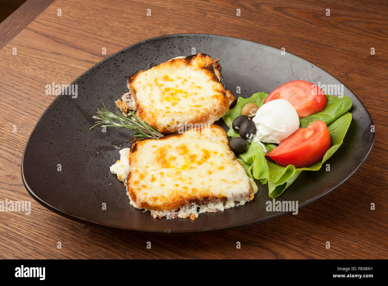 fried mozzarella with grilled vegetables on wooden table Stock Photo