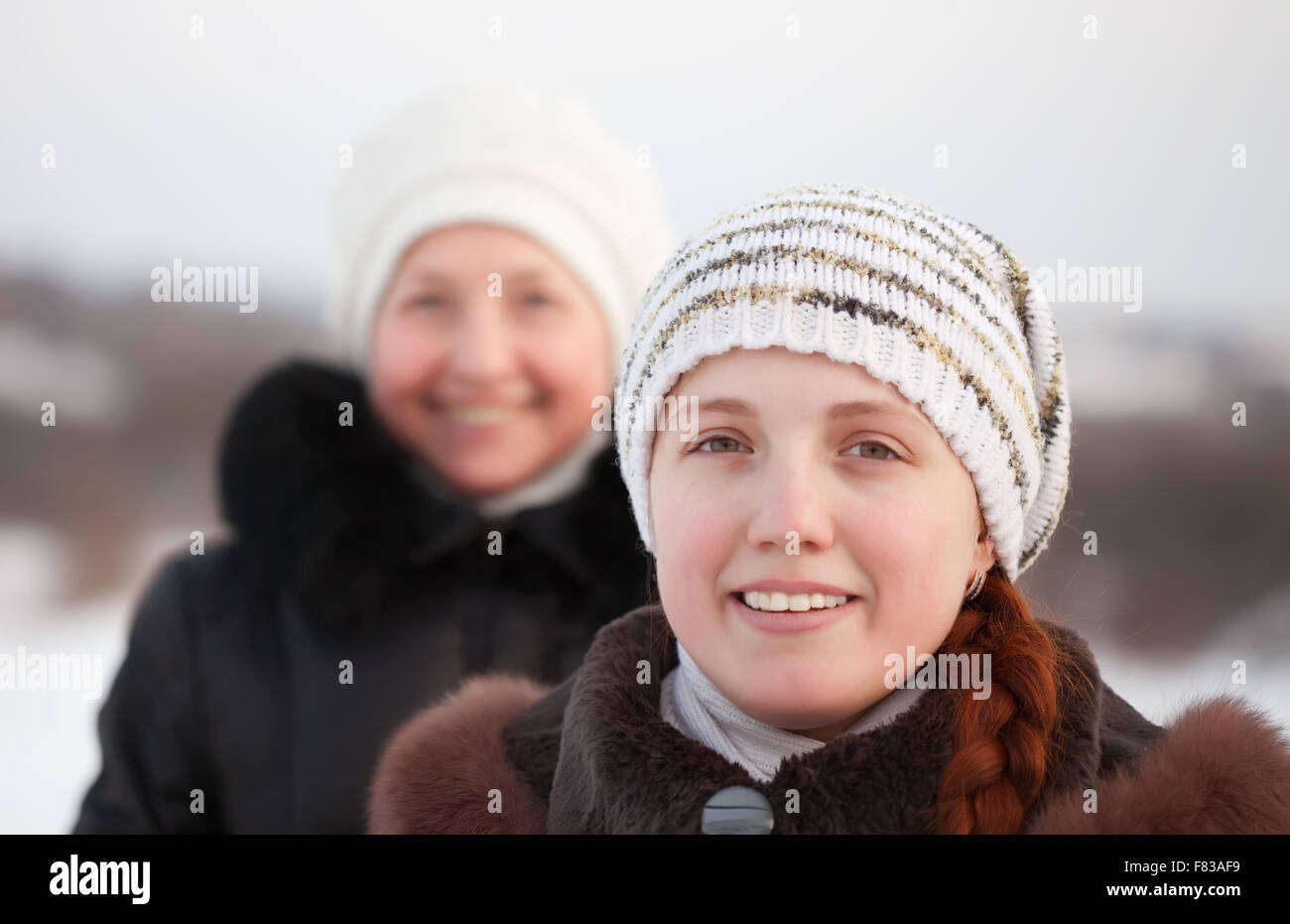 Portrait of two happy women in winter park Stock Photo - Alamy