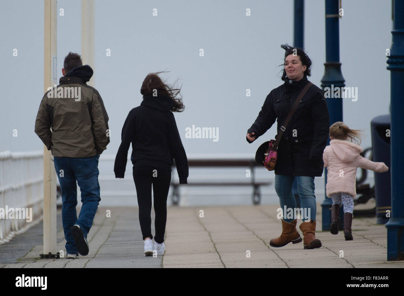Aberystwyth Wales UK, Saturday 05 December 2015  A family get blown about on the promenade as the fourth named storm of the season, Storm Desmond, picks up strength and begins to batter the coast at Aberystwyth, west Wales  photo: © Keith Morris / Alamy Live  News Stock Photo