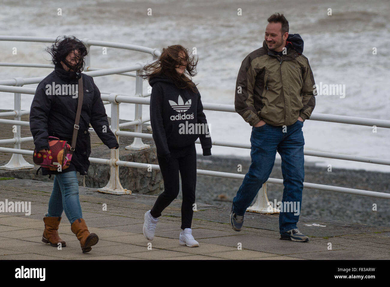 Aberystwyth Wales UK, Saturday 05 December 2015  A family get blown about on the promenade as the fourth named storm of the season, Storm Desmond, picks up strength and begins to batter the coast at Aberystwyth, west Wales  photo: © Keith Morris / Alamy Live  News Stock Photo