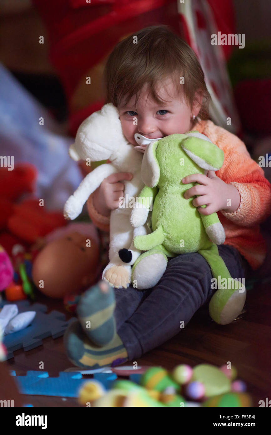 cute little child baby girl playing with toys at home Stock Photo - Alamy