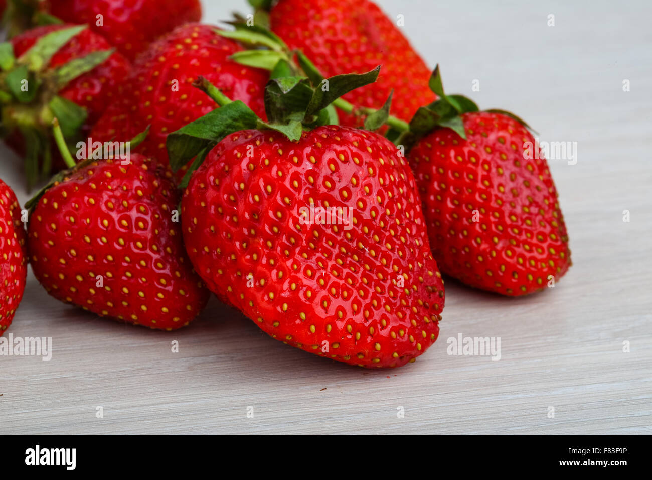Fresh ripe Strawberries in the wooden background Stock Photo - Alamy