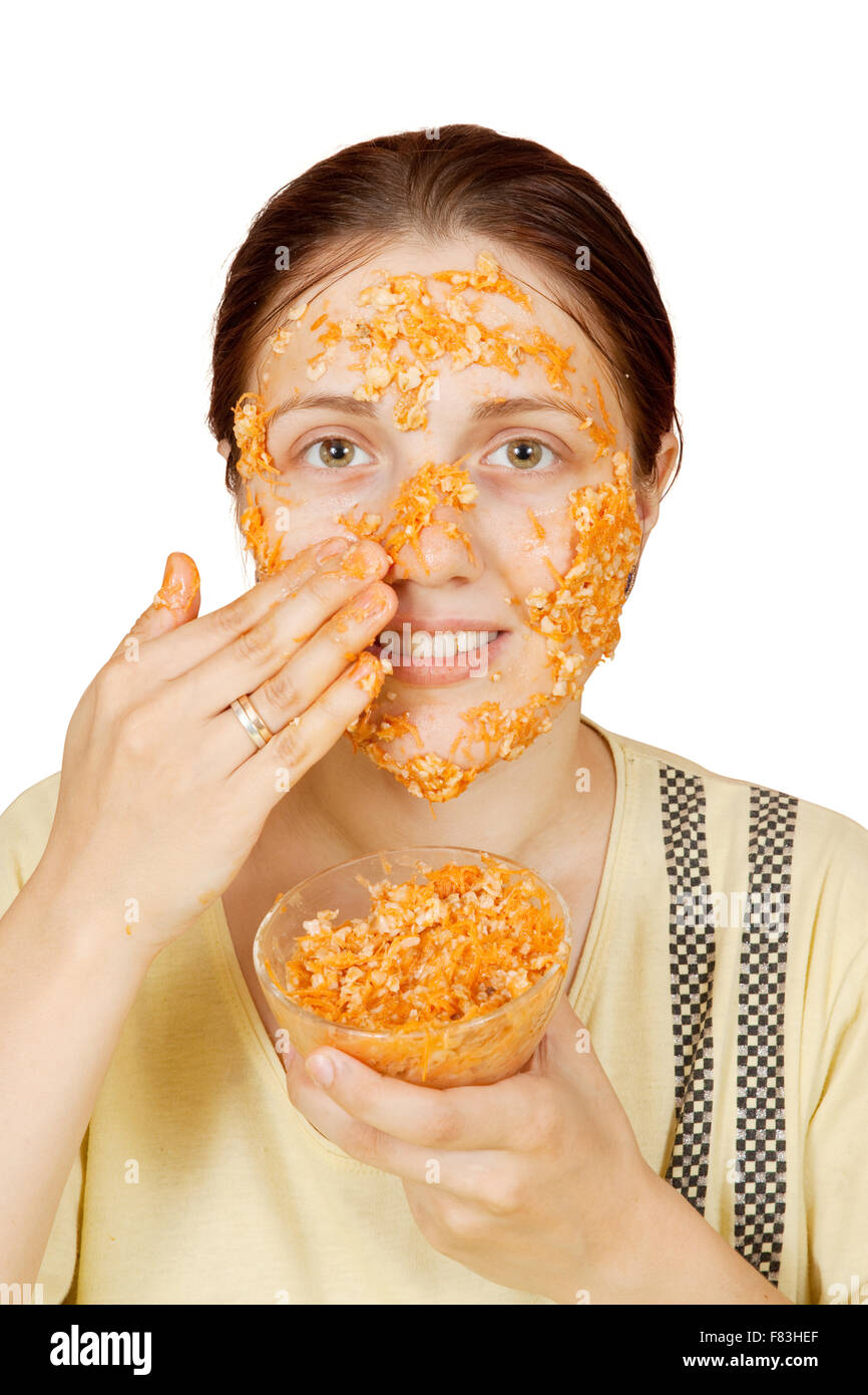 woman making cosmetic pack from carrot, oatmeal and egg yolk Stock