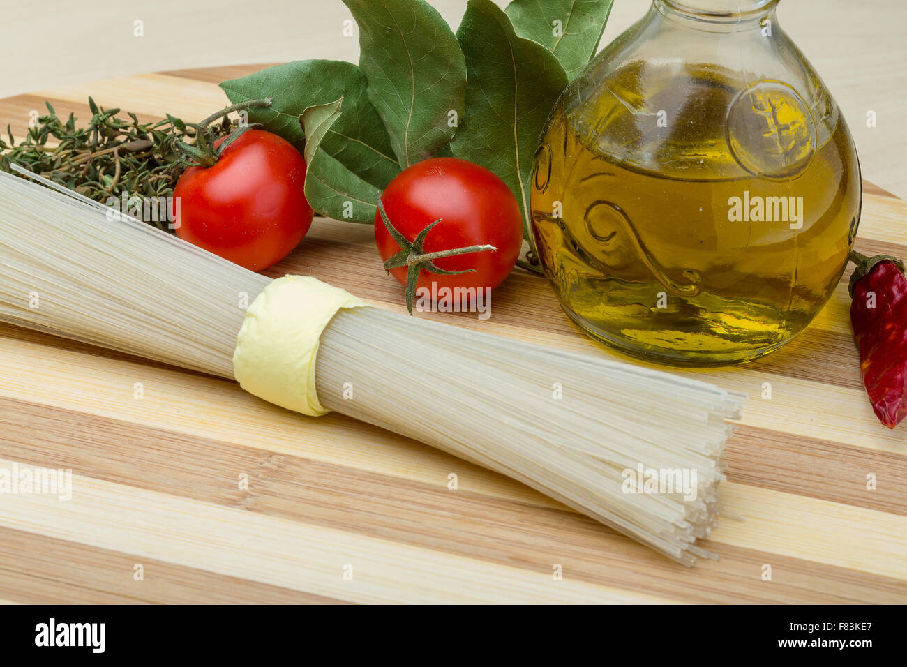 Spaghetti With Rice Model Raw rice spaghetti with herbs and olive oil Stock Photo - Alamy