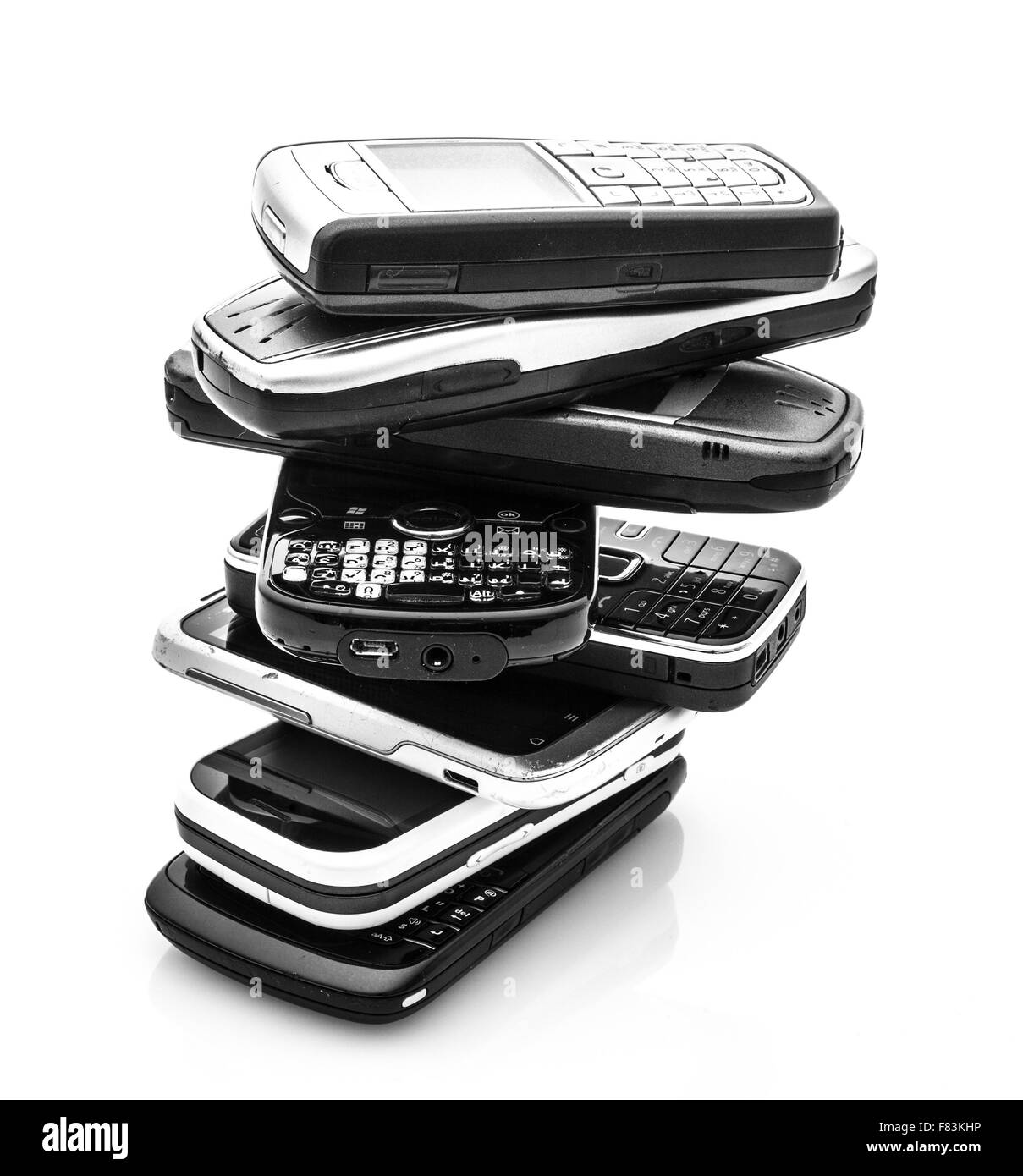 A Collection Of Old Mobile Cell Phones on A White Background Stock Photo