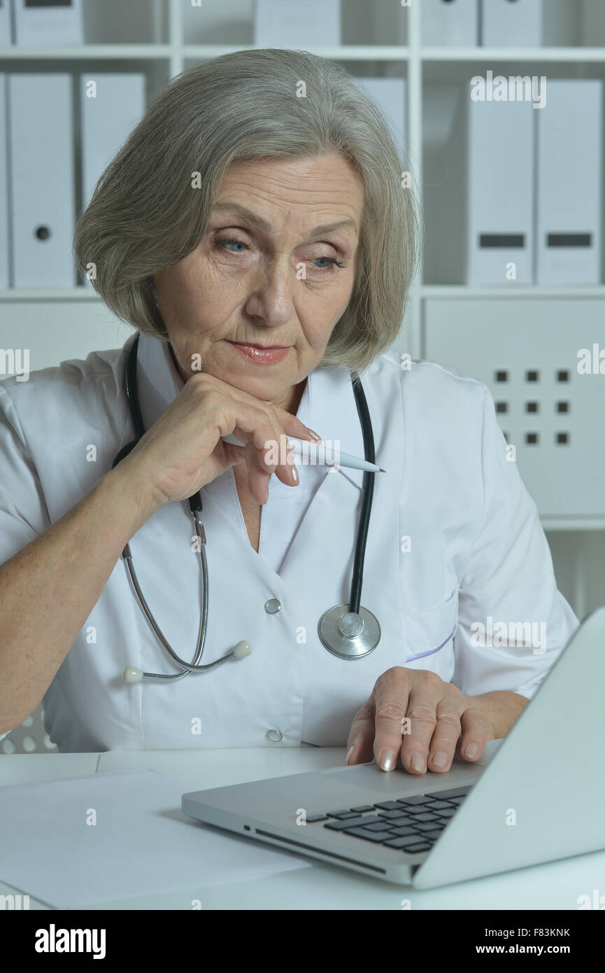 Thoughtful senior doctor Stock Photo - Alamy