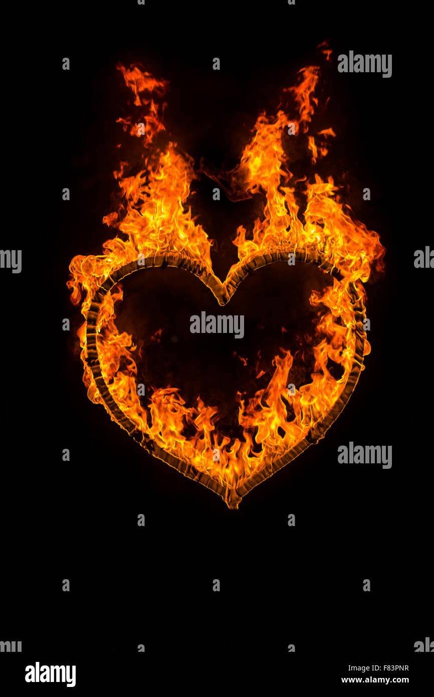 Fire heart at night on black background Stock Photo Alamy