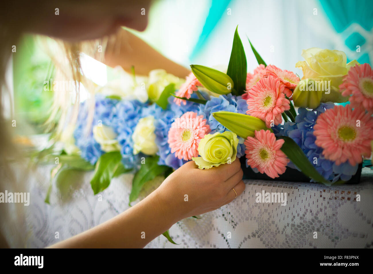 Florist making flower decoration on table Stock Photo