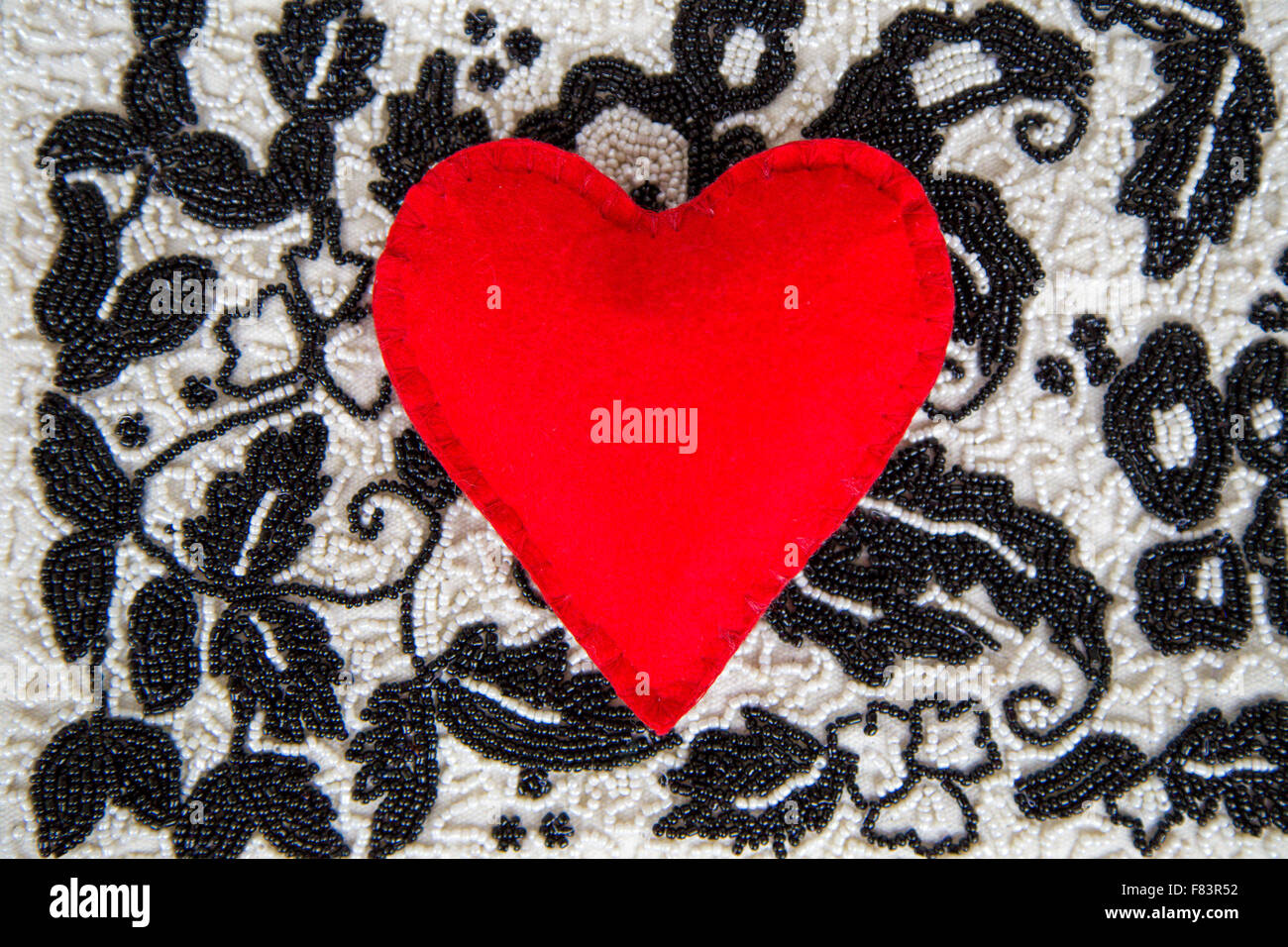 textile red heart on bead background handmade Stock Photo