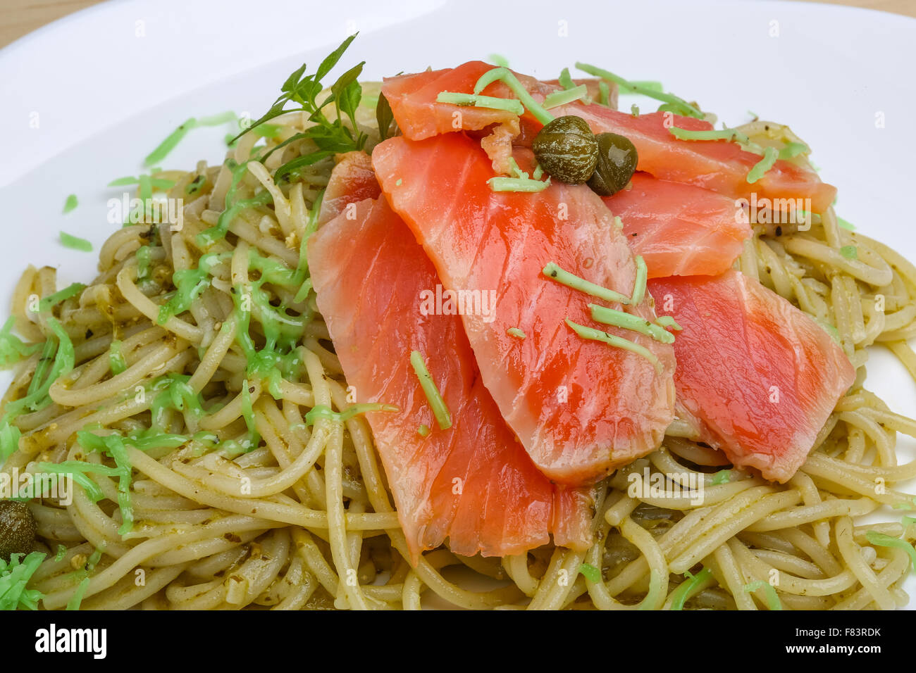 Pasta with salmon, green pesto cheese and capers Stock Photo Alamy